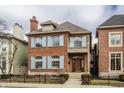 Attractive two-story brick home with light blue shutters, a cozy balcony, and a welcoming entrance at 438 E Vermont St, Indianapolis, IN 46202