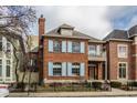 Beautiful two-story brick home with light blue shutters, a classic chimney, and manicured landscaping at 438 E Vermont St, Indianapolis, IN 46202