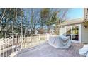 Back patio featuring brick pavers, metal railings, and access to the home's interior at 4618 Angelica Dr, Indianapolis, IN 46237