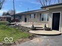 Spacious backyard patio with steps, a bench swing and landscaping at 4823 S State Road 75, Jamestown, IN 46147