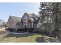 Charming brick two-story home with manicured lawn and inviting entryway at 4927 Auburn Ford, Greenwood, IN 46142