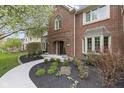 Beautiful brick home with manicured landscaping and a curved walkway leading to the front door at 4978 St Charles Pl, Carmel, IN 46033