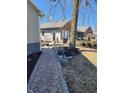 Brick home with landscaped yard and brick paver walkway with outbuilding at 551 E 600 S, Lebanon, IN 46052