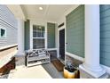 Inviting front porch featuring a bench, columns, and an appealing welcome mat at 568 Lagerfield Dr, Carmel, IN 46032