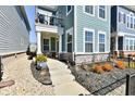 View of the home's inviting front yard and facade, highlighting stone accents and balcony at 568 Lagerfield Dr, Carmel, IN 46032