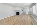 Bright living room featuring light wood floors, a decorative fireplace, and plenty of natural light at 5683 Boy Scout Rd, Lawrence, IN 46226