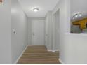 Bright foyer with wood-look floors, a white entry door, and a view of the kitchen at 6525 Emerald Hill Ct # 207, Indianapolis, IN 46237