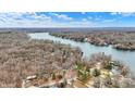 Aerial view of a lake community, showcasing the lake, surrounding trees, and residential homes at 6655 Gopher Dr, Nineveh, IN 46164