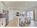 Modern kitchen featuring a breakfast bar with seating, stainless steel appliances, and white cabinetry at 7256 Firestone Rd, Whitestown, IN 46075