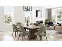 Elegant dining area with modern chandelier, stylish seating for six, and lots of natural light at 7310 Raybourn Ct, Indianapolis, IN 46259