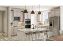A beautifully designed kitchen featuring a large island, modern appliances, and stylish backsplash at 7310 Raybourn Ct, Indianapolis, IN 46259