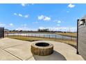 Backyard featuring a stone fire pit and a view of the community pond at 8523 Hulton Rd, Pendleton, IN 46064