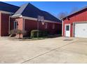 Angled exterior of the home and the detached garage with a basketball hoop in the driveway at 10476 N Prairie Hills Dr, Mooresville, IN 46158