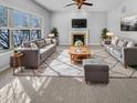 Bright and airy living room with fireplace, large windows, two sofas, and stylish decor at 1059 Sugar Maple Dr, Greenwood, IN 46143
