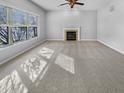 Inviting living room with a cozy fireplace, carpet, and large window, perfect for relaxation at 1059 Sugar Maple Dr, Greenwood, IN 46143
