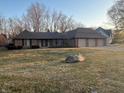 Ranch home with manicured lawn and a three car garage at 10610 Stormhaven Way, Indianapolis, IN 46256