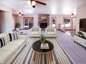 Bright living room featuring a fireplace, neutral carpet, and seating, creating a welcoming atmosphere at 1195 Chad Ct, Plainfield, IN 46168