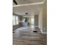 Open-concept living area with gray vinyl floors, pendant lights, and a breakfast bar at 1237 E 29Th St, Anderson, IN 46016