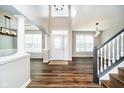 Spacious foyer with hardwood floors, soaring ceilings, arched entryways, and a grand staircase with black trim at 12959 Reedy Ct, Carmel, IN 46032