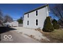 Exterior shot of the side of the house with a gravel driveway and a detached garage for ample parking or storage at 1334 Hannibal St, Noblesville, IN 46060