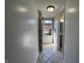 Hallway featuring neutral paint, tile flooring, and a view of the entry and bathroom at 1344 Tishman Ln # 1344, Indianapolis, IN 46260
