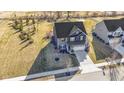 A beautiful aerial view showcases this two-story home's landscaping and outdoor space at 13615 Moorcroft Dr, Fishers, IN 46037