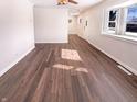Inviting living room space with attractive wood flooring and a modern ceiling fan at 1378 South St, Noblesville, IN 46060
