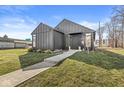 Modern home with striking black siding, well-maintained lawn, and a concrete walkway at 1510 Columbia Ave, Indianapolis, IN 46202