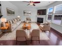 Inviting living room with cozy fireplace, plush seating, and hardwood floors, perfect for relaxation at 15704 Millwood Dr, Noblesville, IN 46060