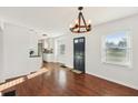 Inviting living room with hardwood floors, a stylish chandelier, and easy access to the adjacent kitchen at 1953 N Linwood Ave, Indianapolis, IN 46218