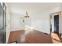 Bright living room boasting hardwood floors, white walls, and a modern chandelier, offering a comfortable living space at 1953 N Linwood Ave, Indianapolis, IN 46218