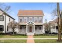 Charming two-story home with a landscaped front yard and inviting porch at 2299 Glebe St, Carmel, IN 46032