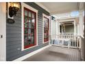 Cozy front porch featuring a swing and classic architectural details at 2299 Glebe St, Carmel, IN 46032