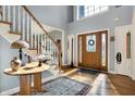 Inviting foyer with hardwood floors, a staircase, and a decorative front door with sidelights at 2750 Joshua Dr, Carmel, IN 46033
