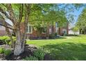Well-kept lawn with a beautiful tree and lush landscaping at 2750 Joshua Dr, Carmel, IN 46033