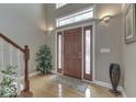 Inviting foyer with a solid wood front door, sidelights, and gleaming hardwood floors at 2861 Shadwell Pl, Greenwood, IN 46143