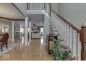 Open foyer with staircase, wood floors, neutral walls, and views into other living spaces at 2861 Shadwell Pl, Greenwood, IN 46143