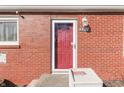 Inviting front entrance with a vibrant red door, enhancing the home's welcoming facade at 3044 S Keystone Ave, Indianapolis, IN 46237