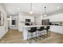 Modern eat-in kitchen with white cabinets, countertops, stainless steel appliances, and seating at the center island at 3304 Morab Dr, Zionsville, IN 46077