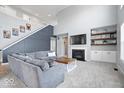 Cozy living room featuring a fireplace, built-in shelves, and comfortable seating area at 348 Entrance Hall, Greenwood, IN 46142