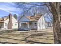 A charming, well-maintained home featuring a stone exterior, inviting front porch, and a neatly kept yard at 3701 N Temple Ave, Indianapolis, IN 46218