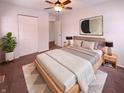 Well-lit bedroom with a ceiling fan, soft carpet, and a comfortable bed at 3743 Celtic Dr, Indianapolis, IN 46235