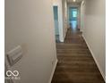 Hallway featuring beautiful hardwood floors and neutral-colored walls that create a clean and modern feel at 3912 Bamboo Branch Dr, Clayton, IN 46118