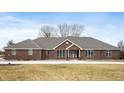 Charming brick home featuring a classic design and welcoming curb appeal on a large lot at 3949 W 250 N, Anderson, IN 46011
