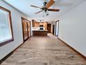 Open-concept living room and kitchen area with hardwood floors and a ceiling fan at 4109 E Epler Ave, Indianapolis, IN 46237