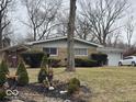 Single-story home with brick facade, well manicured shrubs, and a charming front yard ready for landscaping at 4125 Dequincy St, Indianapolis, IN 46226