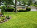 Beautiful single-story home with a well-manicured lawn and tidy landscaping at 4125 Dequincy St, Indianapolis, IN 46226