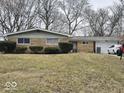 Lovely single-story home featuring a brick facade and attached one car garage, situated on a well maintained lawn at 4125 Dequincy St, Indianapolis, IN 46226