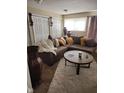 Inviting living room featuring a brown sectional sofa, soft rug, and decorative accents at 4125 Dequincy St, Indianapolis, IN 46226