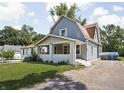 View of the house shows a covered front porch, blue siding, and a well-manicured lawn at 4429 Crittenden Ave, Indianapolis, IN 46205